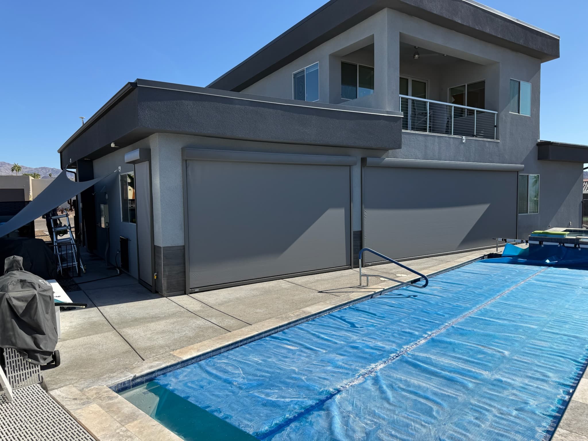 Patio shades lowered beside a Phoenix pool